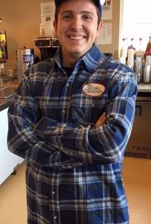 A student wearing a long sleeve flannel shirt with UDairy Creamery logo